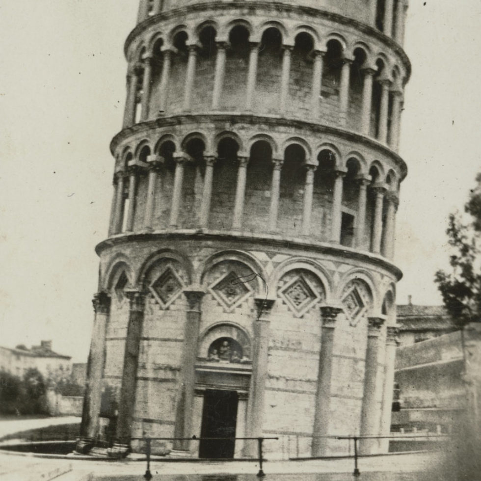 Image: The famous cylindrical tower, leaning to the right with puddles forming on the ground in front.