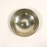 Image: silver dish featuring engraving around its lip. The engraving includes maker's marks and the logo of Vickers for both 1919 and 1969.